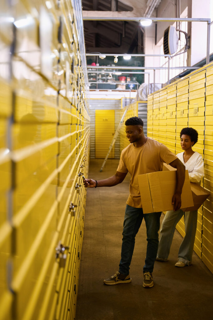 Couple placing boxes in secure self-storage units, ensuring safety and space efficiency